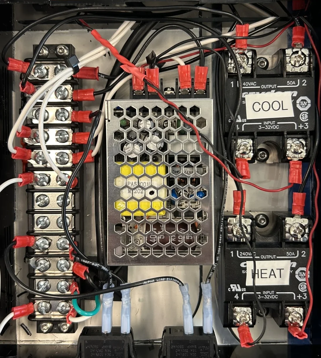 The repurposed chiller with the USB DAQ on top (left), and inside the controller box, where solid-state relays switch the chiller's heating and cooling (right)