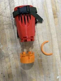 The custom-fitted socket with an attachment locked in (left), and exploded to show the twist-lock base and retaining clip (right)