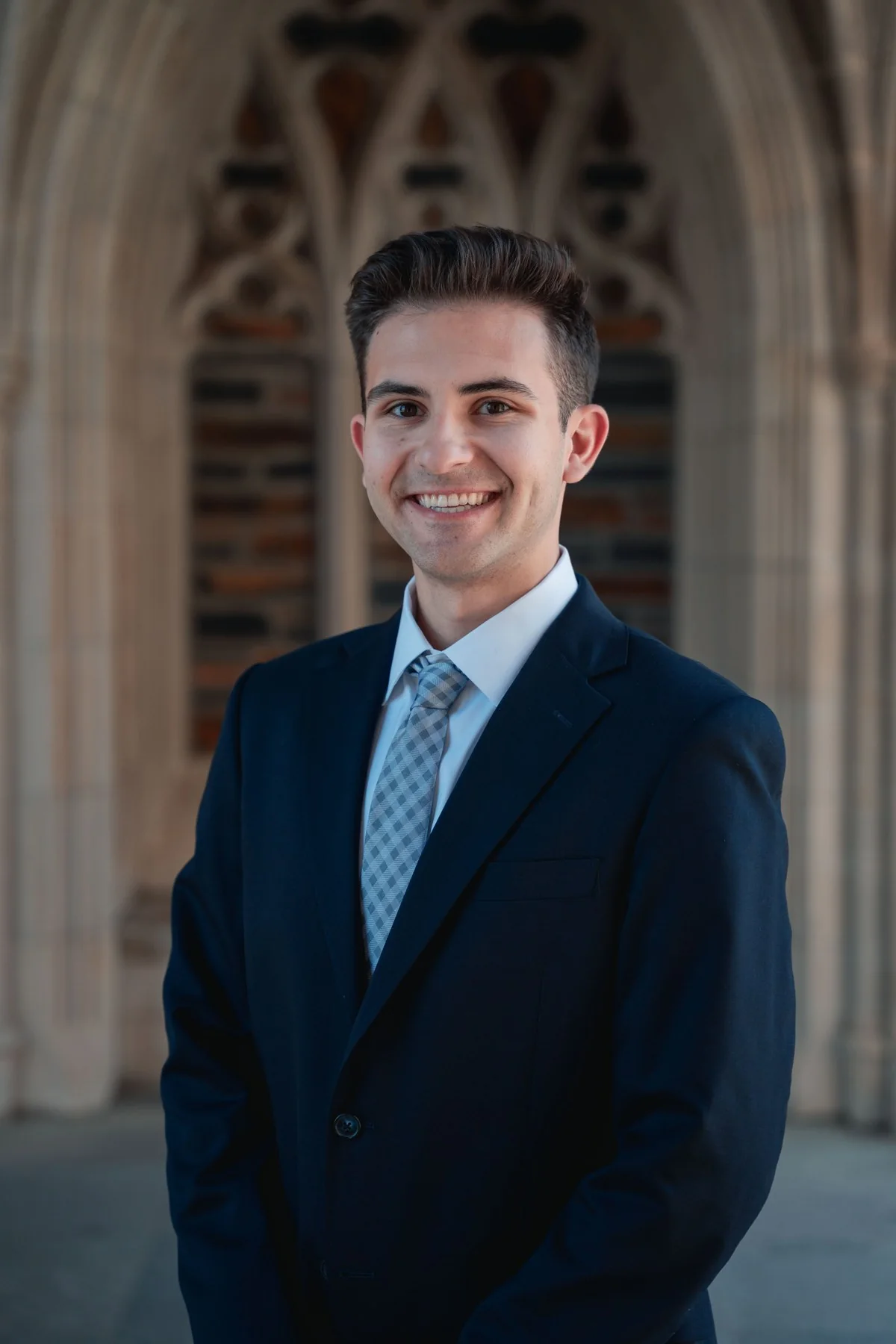 Carson Pazdan in a navy suit outside Duke Chapel