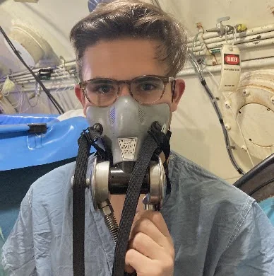 An early prototype failing its water-leak test (left), water-testing the seal at the IV pole clamp (center), and suited up for the test dive in Duke's hyperbaric chamber (right)